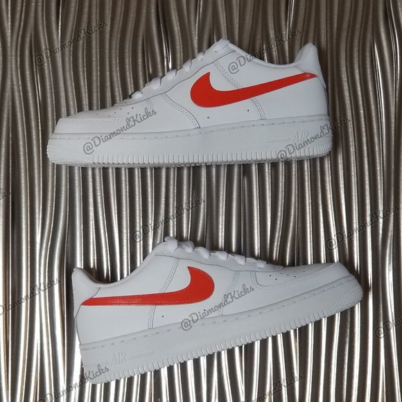 white and black air forces with orange lettering